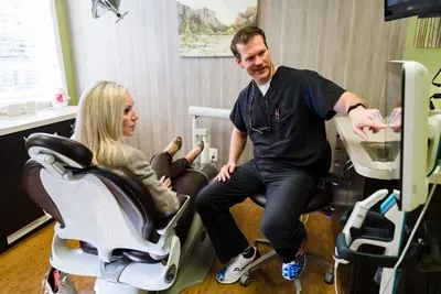 Dr. Cutting discussing dental treatment with a patient at Edgewater Dental Arts