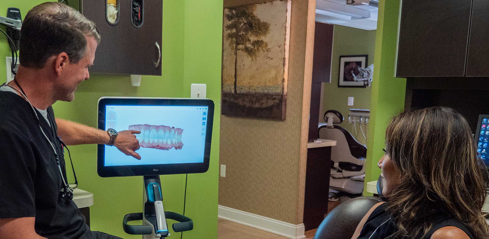 Dr. John Cutting speaking to patient